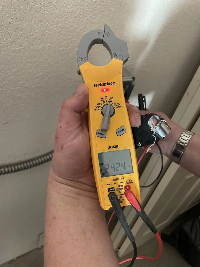 Voltage testing with clamp meter during Ceiling Fan Installation in Taylor